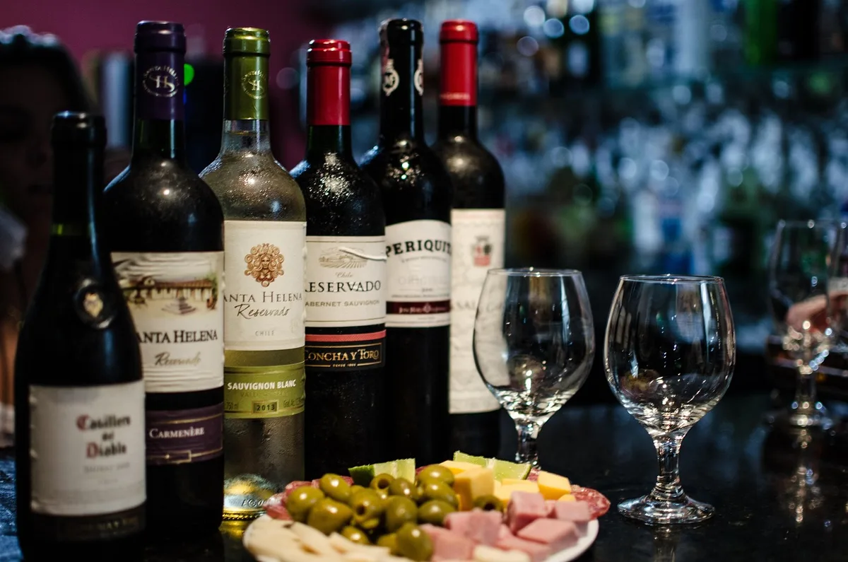 Sélection de bouteilles de vin rouge et un verre sur une table pour choisir le vin
