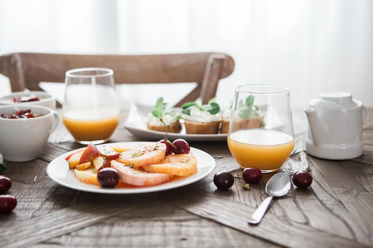 Famille partageant le même plat à table dans une cuisine lumineuse