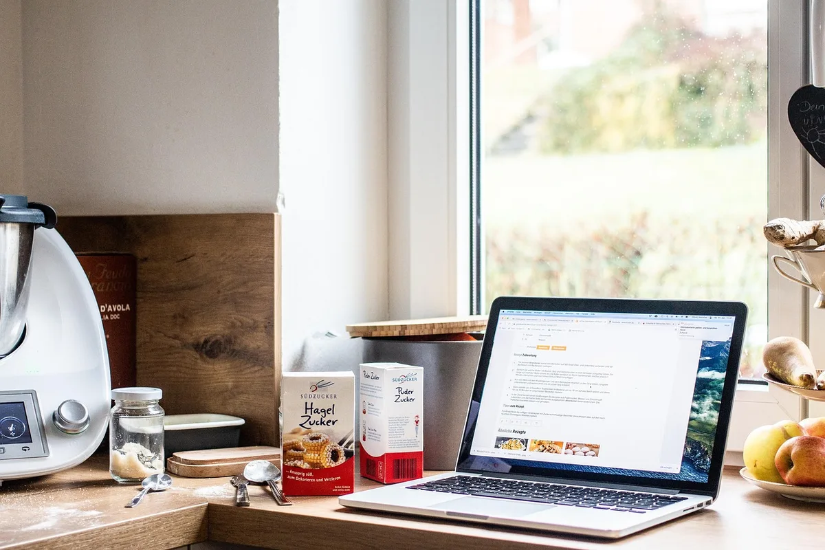 Personne préparant un smoothie dans une cuisine ensoleillée